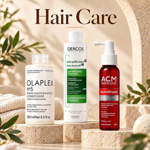 Haircare promotional banner featuring Vichy Dercos Anti-Dandruff Shampoo, The Ordinary Multi-Peptide Serum for Hair Density, and Olaplex No. 3 Hair Perfector 100ml on a stone display.